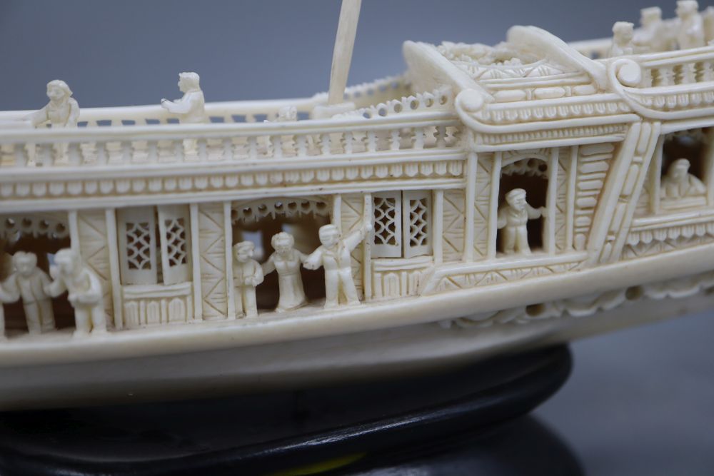 A Chinese carved ivory boat, on stand, length 23cm